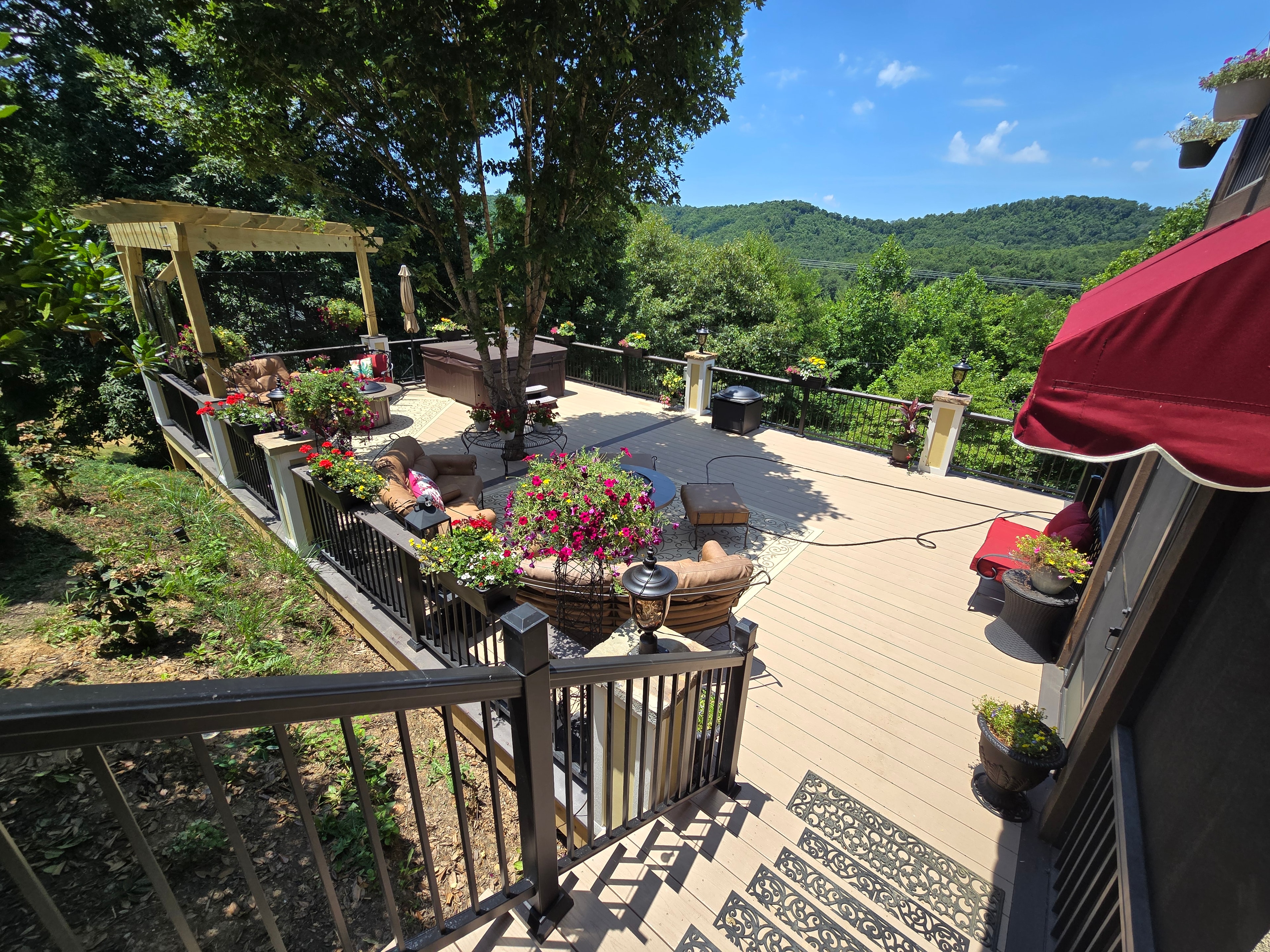Aerial view of a custom residential deck with pergola in the mountains